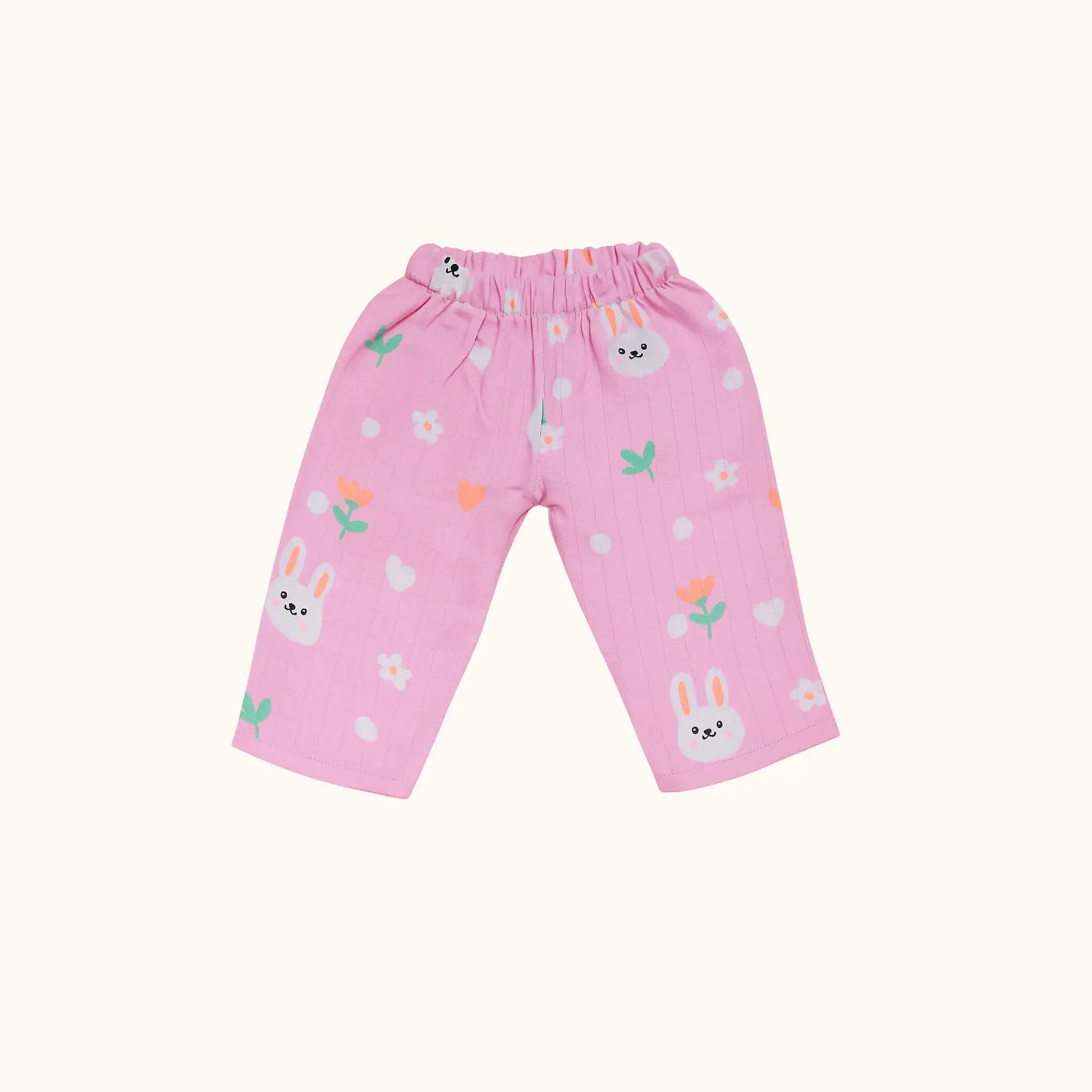 Pink children's pants with bunny and flower pattern on a white background