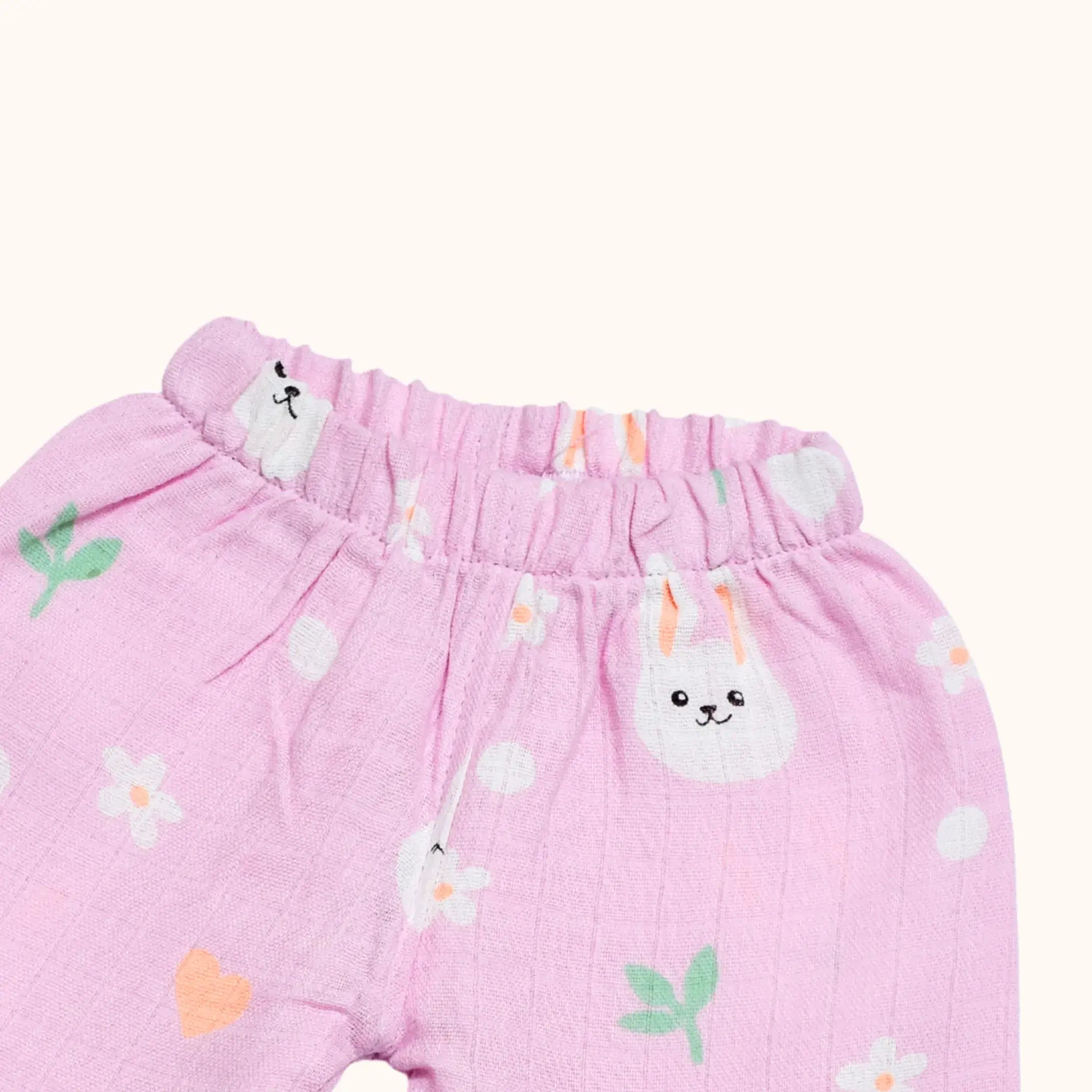 Pink baby pants with animal prints on a white background