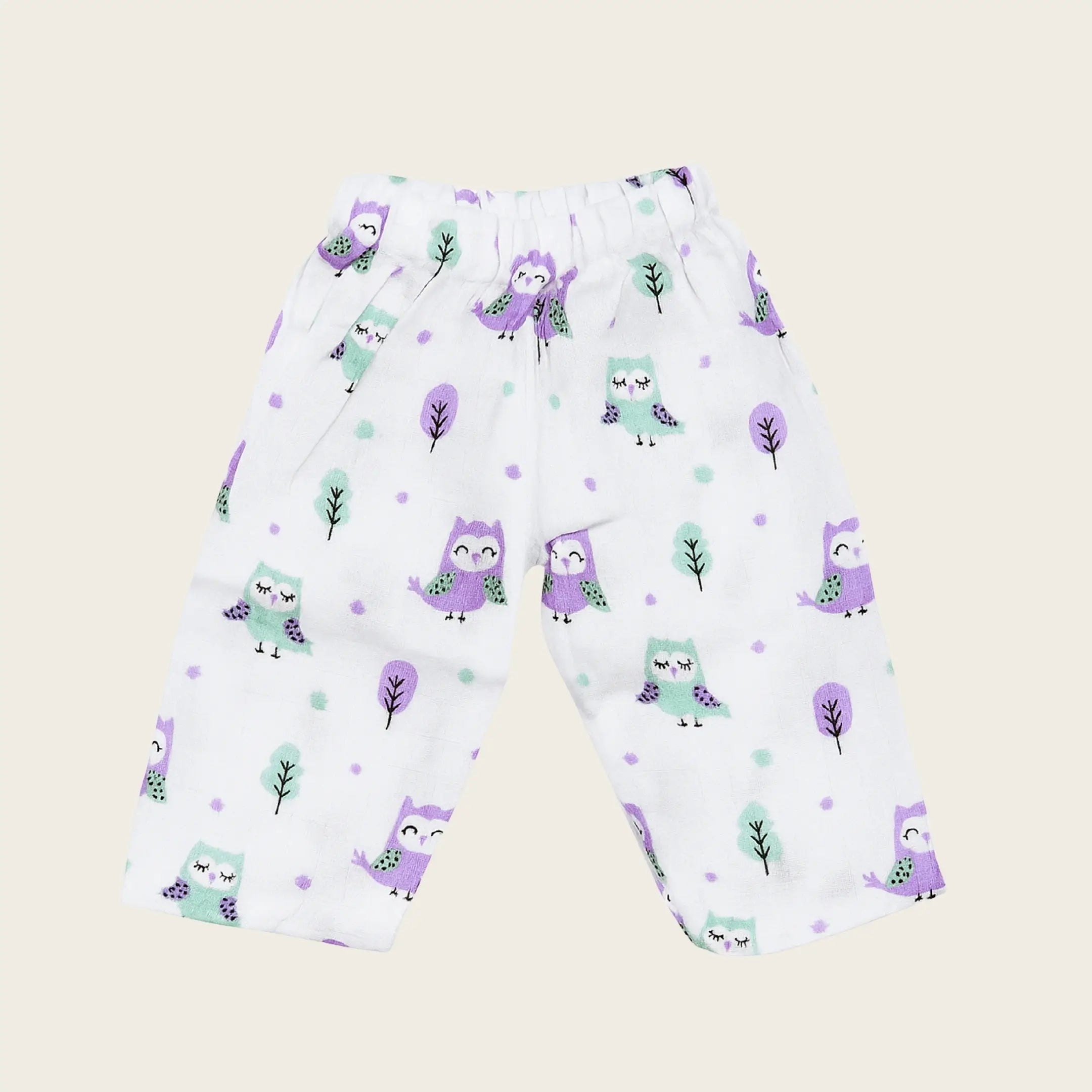 Children's pants with purple owl pattern on a beige background