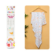 Cutetales Baby muslin swaddle with colorful patterns on a yellow surface next to its packaging.