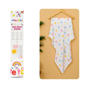 Cutetales Baby swaddle with colorful patterns on a beige surface next to its packaging.