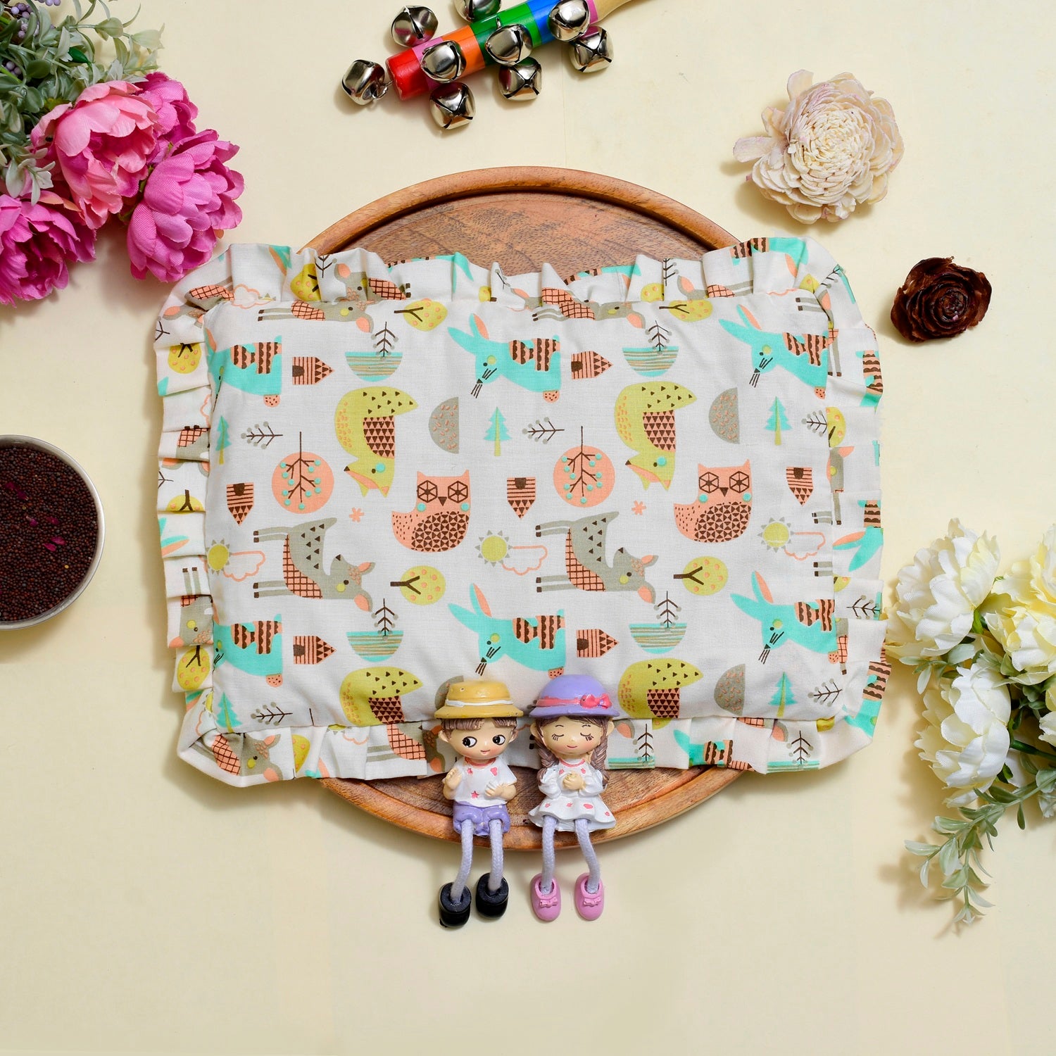 Cotton Fabric pillow with nature-themed pattern on a wooden board with decorative items