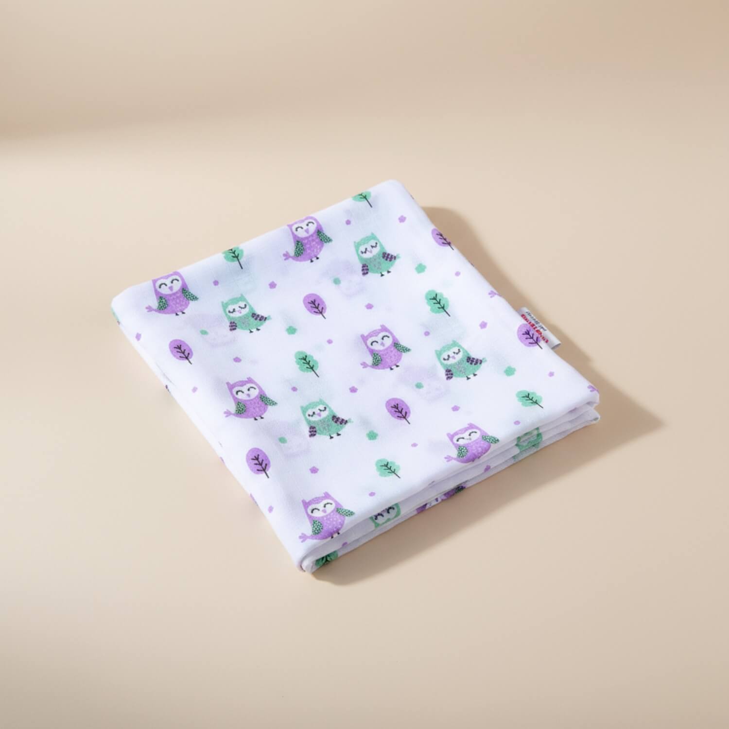 Cutetales Folded fabric with owl pattern on a beige background